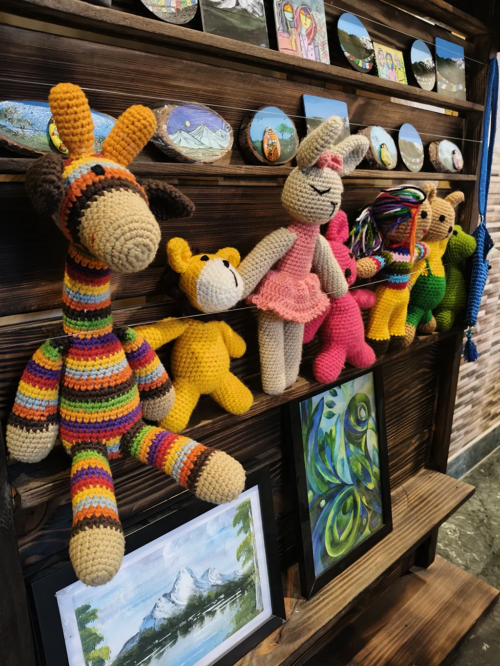 Naggarte art studio shelf with handmade crafts and paintings